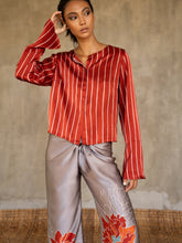 Load image into Gallery viewer, Quarzia artisanal short jacket in red color and white stripes wear on a silk long pant with floral decoration grey/pink. Made in Bali.