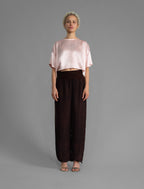 Front view. Slightly cropped boxy 100% silk stretch t-shirt in soft pink with raw cut detail on neckline and sleeves.