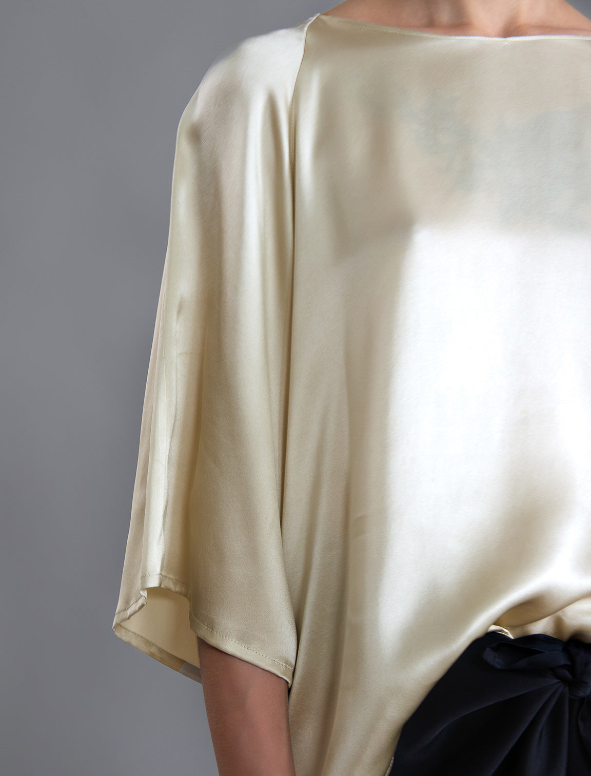 Sleeve detail 1. Lightweight 100% silk satin top in ivory colour, features a wide neckline with a button fastening at the back, a gently curved hemline and wide sleeves 3/4 length sleeves.