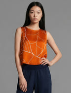 Front view. 100% silk short length stretch singlet with linear leaf motif on orange colour with open neckline and wide shoulder straps.