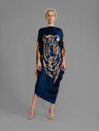 Front View. Navy Blue silk batik dress with bold handmade Tiger batik motif in gold, draped silhouette and artisanal craftsmanship from Bali.