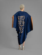 Back view. Navy Blue silk batik dress with bold handmade Tiger batik motif in gold, draped silhouette and artisanal craftsmanship from Bali.