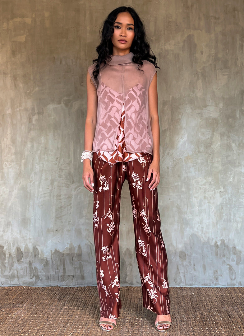 sleeveless silk crepe top pink color on top of a silk satin pant color rusty with batik decoration made in Bali