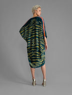 Back view. Relaxed flowing silk kaftan with graphic light green zebra motif on teal colour, with purple detail, featuring 3/4 length sleeves and a voluminous silhouette.