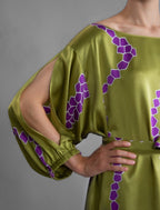 Sleeve detail. Full length 100% silk tunic dress with purple macrosnake motif on moss green colour, featuring a open, wide neckline and one side split on the skirt, gathered 3/4 length sleeves with a slash opening and optional ribbon belt.