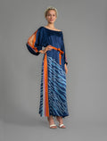 Front view with belt. Full length 100% silk tunic dress with blue zebra motif and orange details on navy blue colour, featuring a open, wide neckline and one side split on the skirt, gathered 3/4 length sleeves with a slash opening and optional ribbon belt.
