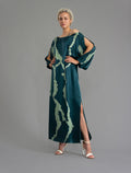 Front view without belt. Full length 100% silk tunic dress with light green macrosnake motif on teal colour, featuring a open, wide neckline and one side split on the skirt, gathered 3/4 length sleeves with a slash opening and optional ribbon belt.
