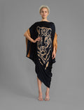 Front view. Elegant silk kaftan dress with tiger head batik motif on black color silk, featuring flowing kimono sleeves, asymmetrical hemline, and relaxed contemporary silhouette.
