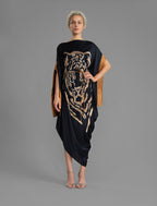 Front view with belt. Elegant silk kaftan dress with tiger head batik motif on black color silk, featuring flowing kimono sleeves, asymmetrical hemline, and relaxed contemporary silhouette.