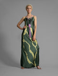 Front view. Elegant long body contouring silk dress in forest green colour with contrasting green graphic Macrosnake batik motif, featuring spaghetti straps, V-neckline and a fluid contemporary silhouette.