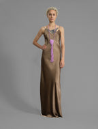Front view. Elegant long body contouring silk dress in soft mocha colour, featuring spaghetti straps, V-neckline and a fluid contemporary silhouette.