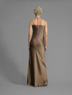 Back view. Elegant long body contouring silk dress in soft mocha colour, featuring spaghetti straps, V-neckline and a fluid contemporary silhouette.