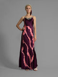 Front View. Elegant long body contouring silk dress in deep vino colour with contrasting pink graphic Macrosnake batik motif, featuring spaghetti straps, V-neckline and a fluid contemporary silhouette.