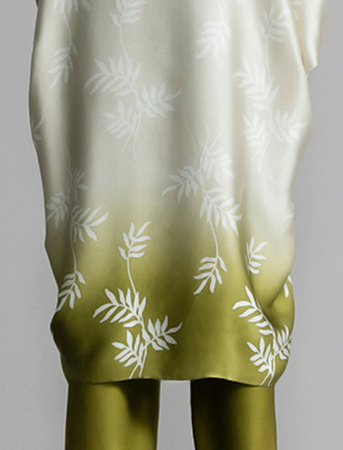 Motif detail: Relaxed flowing silk kaftan with subtle Dedaun leaf motif in moss green and white colour, featuring 3/4 length sleeves and a voluminous silhouette.