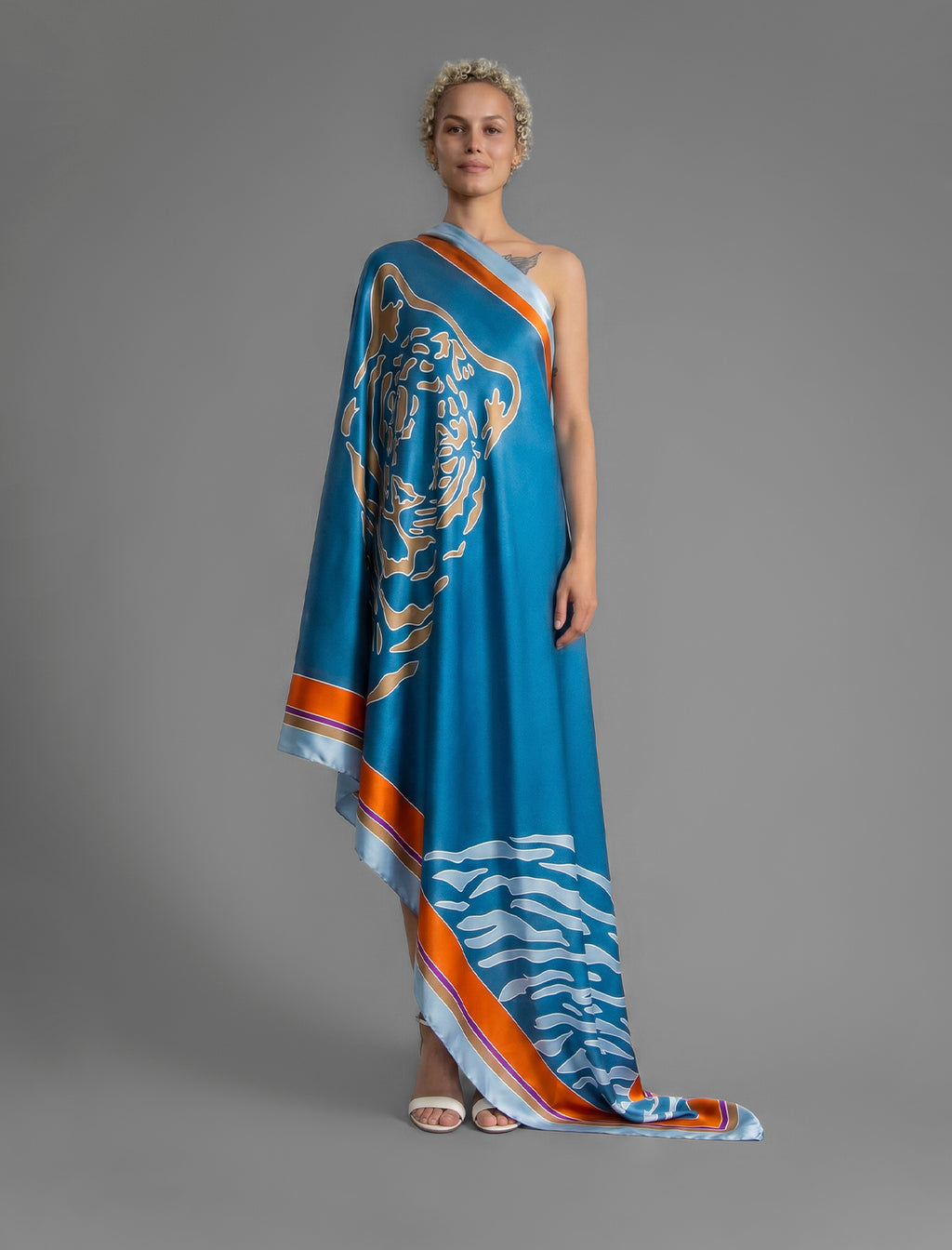 Silk hand-crafted, hand-painted batik sarong in dream blue colour with gold tight and pale blue zebra motif.