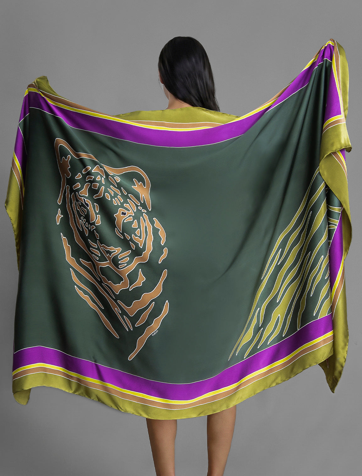 Detail View. Silk hand-crafted, hand-painted batik sarong in forest green colour with gold tight and lime green zebra motif.