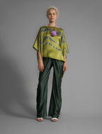 Variation 2. Flowing moss green colour silk top with graphic Macrosnake batik motif in contrasting green tone, featuring fluid draped sleeves, asymmetrical hemline, and versatile contemporary silhouette designed to be worn three ways.