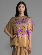 Short sleeve variation. Flowing tobacco colour silk top with graphic Tiger batik motif in contrasting purple, featuring fluid draped sleeves, asymmetrical hemline, and versatile contemporary silhouette designed to be worn three ways.