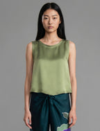 Close front view. Front view. 100% silk short length stretch singlet in fern green colour with open neckline and wide shoulder straps.
 