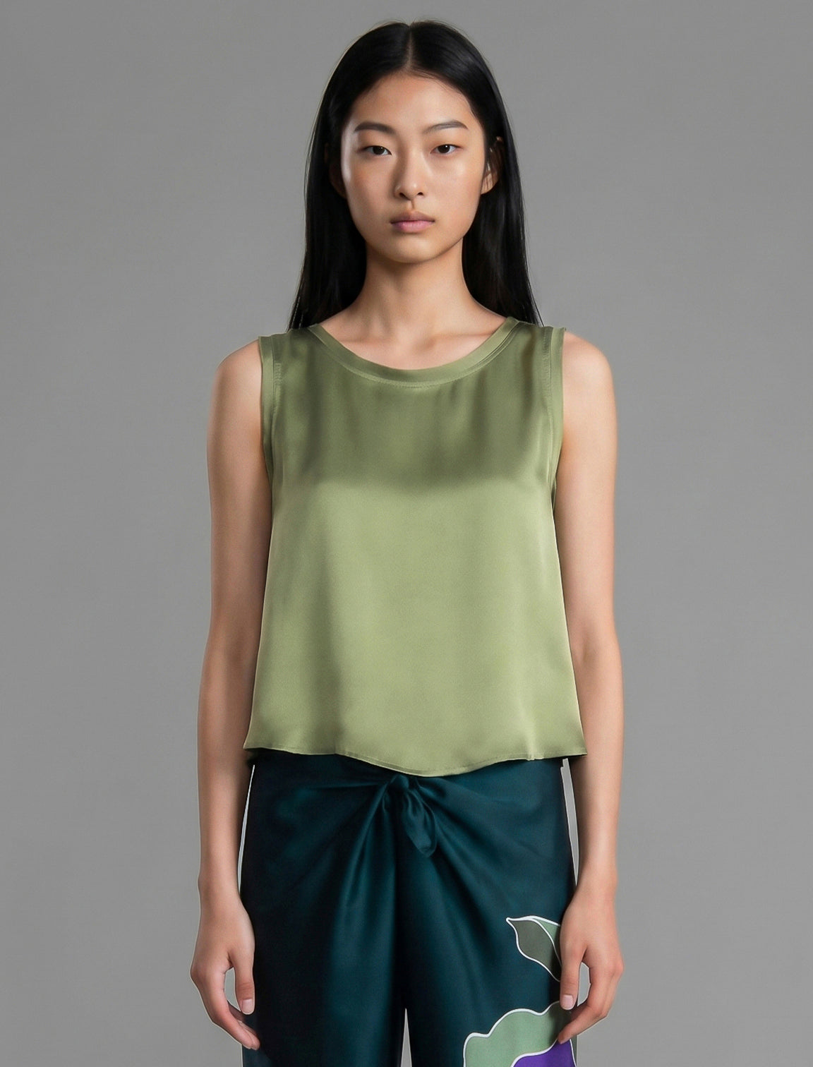 Close front view. Front view. 100% silk short length stretch singlet in fern green colour with open neckline and wide shoulder straps.
 