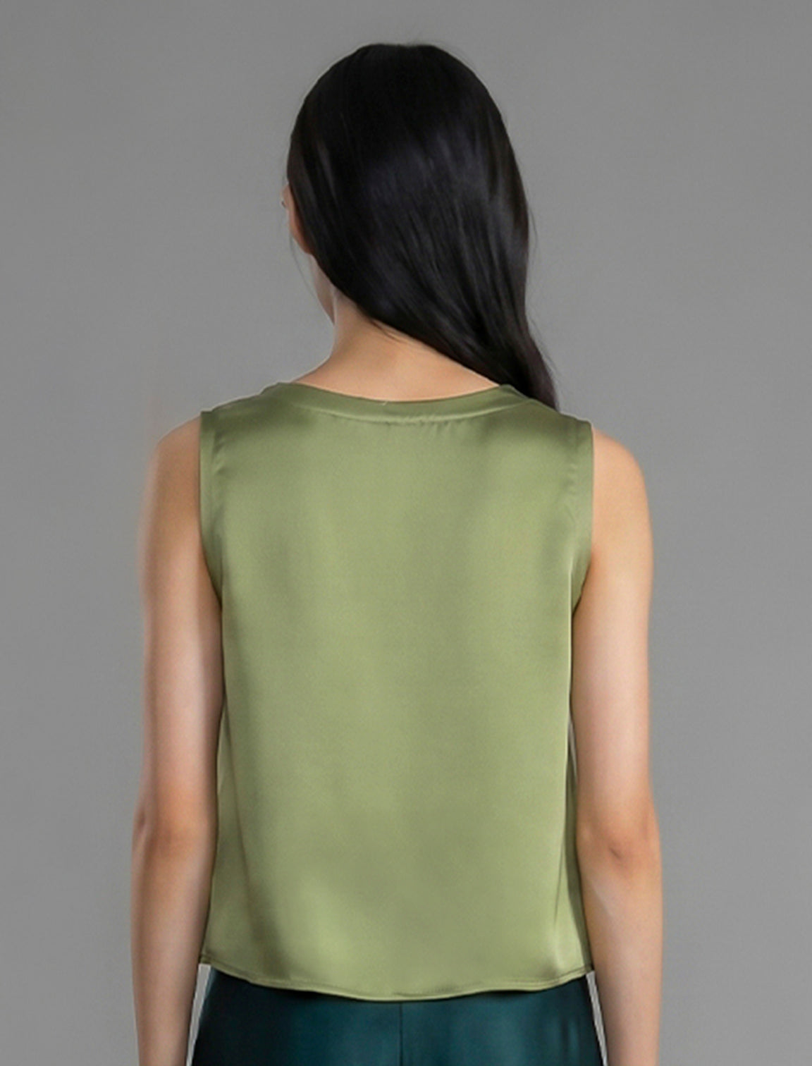 Back view. Front view. 100% silk short length stretch singlet in fern green colour with open neckline and wide shoulder straps.
 