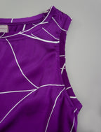Detail view. 100% silk short length stretch singlet with linear leaf motif on purple colour with open neckline and wide shoulder straps.