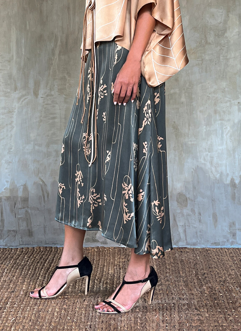 Side detail: Quarzia Aline Skirt, flowing curved hemline gathered panel across the back -delicate hand painted motif handcrafted from premium silk-Lost Grey-crafted by artisans made in Bali