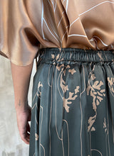 Load image into Gallery viewer, Elasticated waist detail back: Quarzia Aline Skirt, flowing curved hemline gathered panel across the back -delicate hand painted motif handcrafted from premium silk-Lost Grey-crafted by artisans made in Bali
