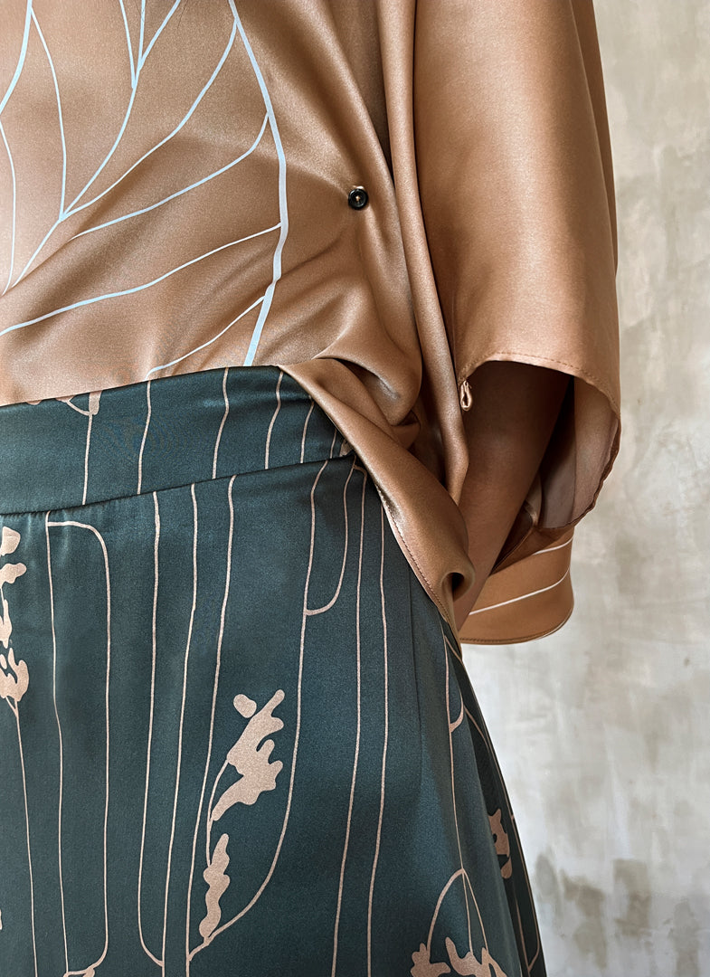 Front waist detail: Quarzia Aline Skirt, flowing curved hemline gathered panel across the back -delicate hand painted motif handcrafted from premium silk-Lost Grey-crafted by artisans made in Bali
