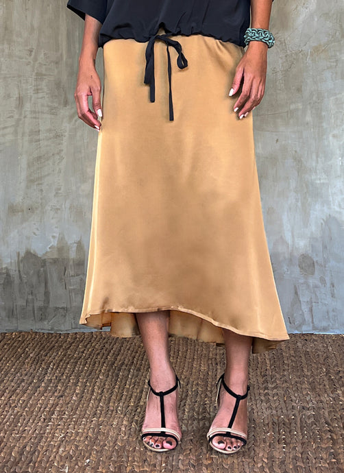 Quarzia Aline Skirt, flowing curved hemline gathered panel across the back-handcrafted from premium rayon. Plain Cashew-color crafted by artisans made in Bali.