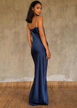 Load image into Gallery viewer, Back detail: this full length slip dress is cut on the bias, allowing a natural drape on the body which is complimented by the delicate spaghetti straps and the gentle, low-cut V-neckline. 
