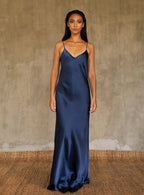 This full length slip dress is cut on the bias, allowing a natural drape on the body which is complimented by the delicate spaghetti straps and the gentle, low-cut V-neckline. 