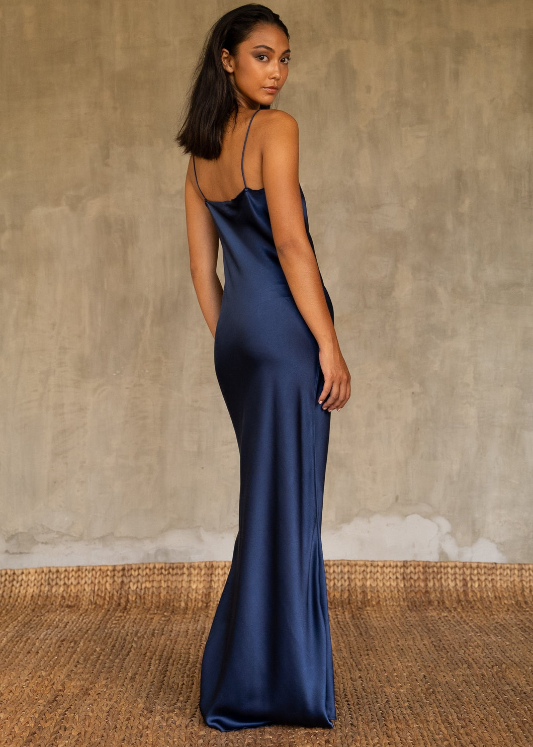 Back detail: this full length slip dress is cut on the bias, allowing a natural drape on the body which is complimented by the delicate spaghetti straps and the gentle, low-cut V-neckline. 