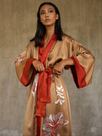 Quarzia signature Kimono has wide, flowing sleeves and it's handcrafted from pure silk satin. As Japanese style' kimono  it is open under the arms, and there's a bold border in contrast color on the cuffs and on the front. A beautiful silk belt also in contrast color frame this elegant piece, ultimate in relaxed style, elegance and comfort. The batik pattern is inspired by  flower and leaves. 