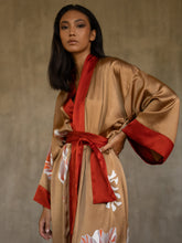 Load image into Gallery viewer, Front detail: Quarzia signature Kimono has wide, flowing sleeves and it&#39;s handcrafted from pure silk satin. As Japanese style&#39; kimono  it is open under the arms, and there&#39;s a bold border on the cuffs and on the front. A beautiful silk belt frame this elegant piece, ultimate in relaxed style, elegance and comfort. The batik pattern is inspired by  flower and leaves. 
