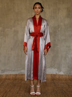 Quarzia signature Kimono has wide, flowing sleeves and it's handcrafted from pure silk satin. As Japanese style' kimono  it is open under the arms. A bold contrast color border on the cuffs and on the front, together with the same color silk belt, frame this elegant piece, ultimate in relaxed style, elegance and comfort. The batik pattern is inspired by the beauty of imperfection in nature.