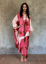 Load image into Gallery viewer, Silk satin handpainted asymmetric long dress in Greenwall botanical pattern in light pink background and darker pink leaves .
