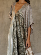 Load image into Gallery viewer, Front detail: the  silk satin grey Ally dress is a celebration of modern batik patterns. Multiple designs, inspired by nature, are hand-crafted on silk in various hues of grey. The generous silhouette will suite all sizes.
