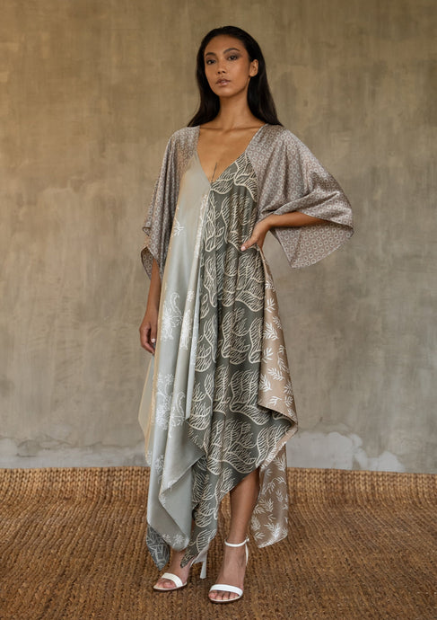 The  silk satin grey Ally dress is a celebration of modern batik patterns. Multiple designs, inspired by nature, are hand-crafted on silk in various hues of grey. The generous silhouette will suite all sizes.