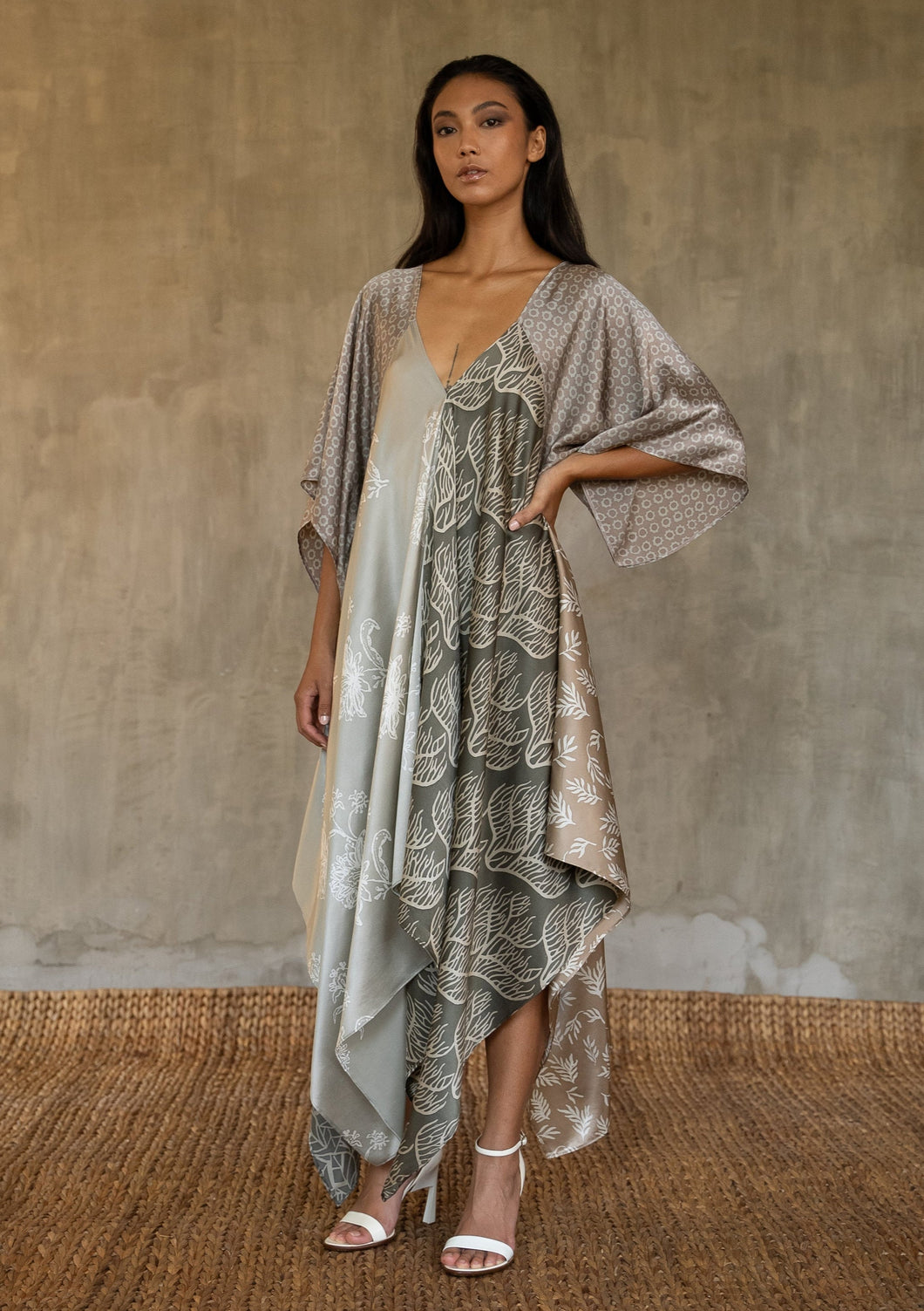 The  silk satin grey Ally dress is a celebration of modern batik patterns. Multiple designs, inspired by nature, are hand-crafted on silk in various hues of grey. The generous silhouette will suite all sizes.