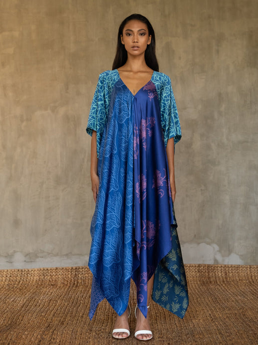 Quarzia artisanal silk satin blue Ally dress is a celebration of modern batik patterns. Multiple designs, inspired by nature, are hand-crafted on silk in various hues of blue. The generous silhouette will suite all sizes. Made in Bali.