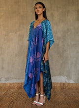 Load image into Gallery viewer, The  silk satin blue Ally dress is a celebration of modern batik patterns. Multiple designs, inspired by nature, are hand-crafted on silk in various hues of blue. The generous silhouette will suite all sizes.
