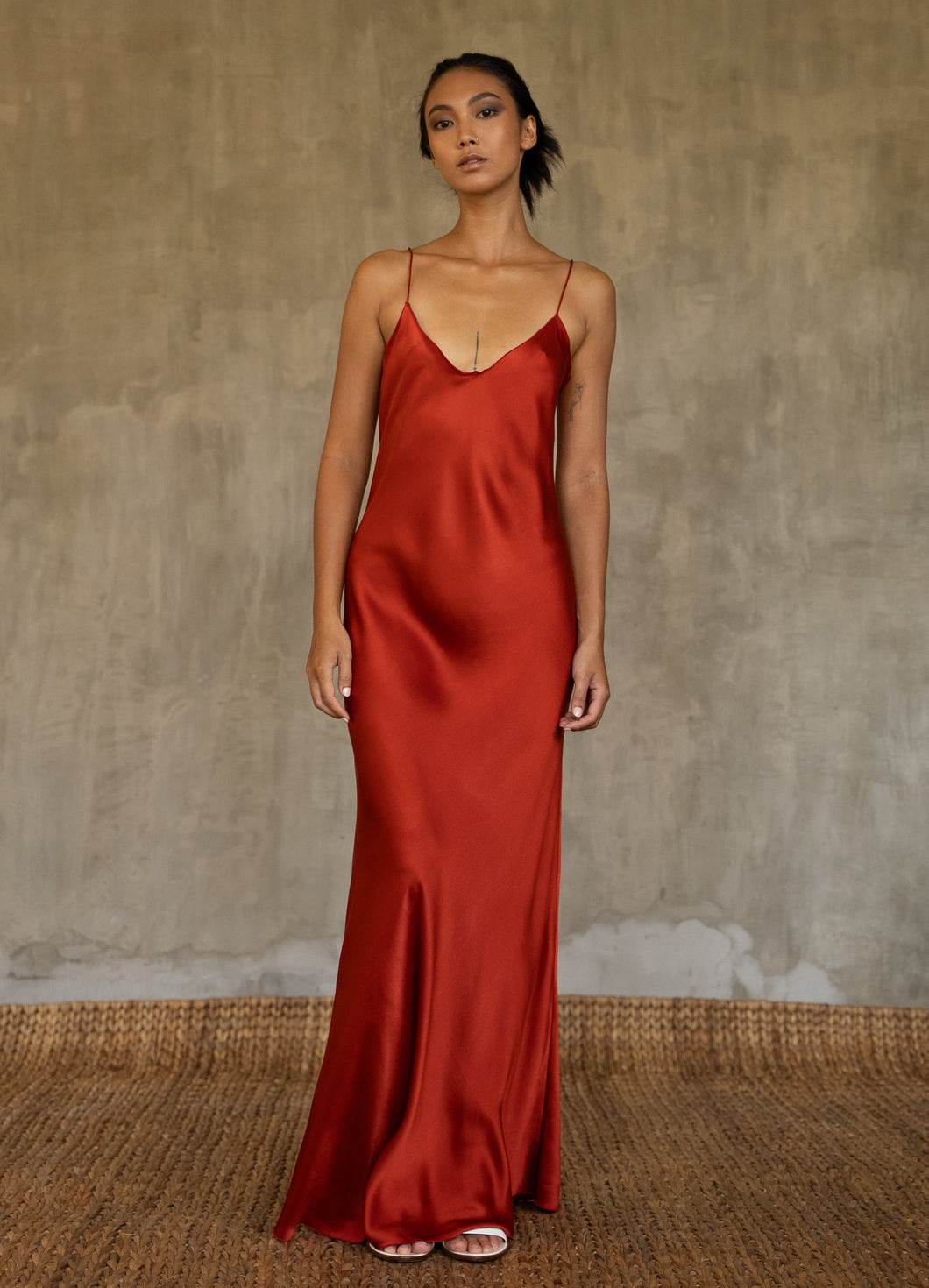 This full length slip dress is cut on the bias, allowing a natural drape on the body which is complimented by the delicate spaghetti straps and the gentle, low-cut V-neckline. 