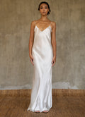 This full length slip dress is cut on the bias, allowing a natural drape on the body which is complimented by the delicate spaghetti straps and the gentle, low-cut V-neckline. 