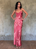 Silk satin handcrafted long spaghetti dress in pink with maxi foliage pattern front and back. Bias cut dress with low V-neckline.