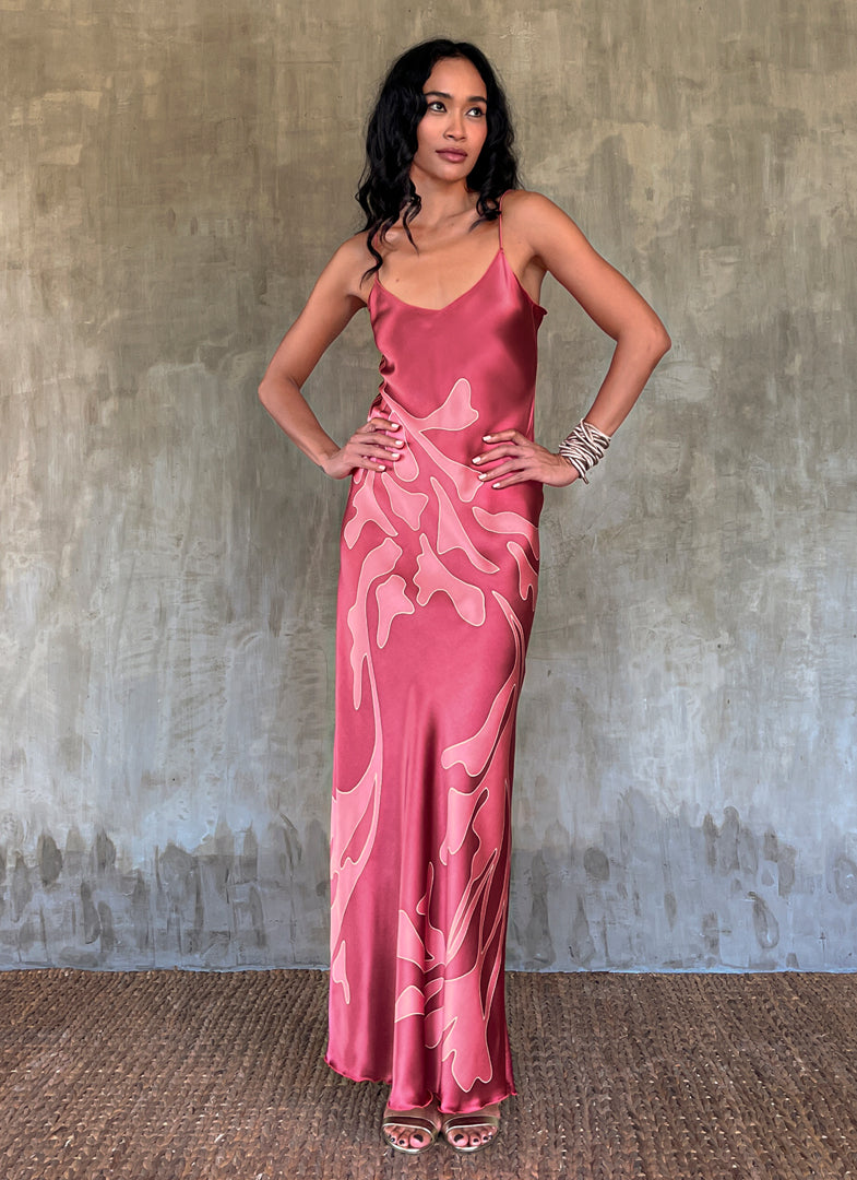 Silk satin handcrafted long spaghetti dress in pink with maxi foliage pattern front and back. Bias cut dress with low V-neckline.