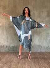 Load image into Gallery viewer, Silk satin handpainted asymmetric long dress in Greenwall botanical pattern in light blue background and darker leaves .
