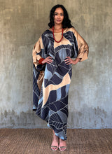 Load image into Gallery viewer, Silk satin handcrafted asymmetric long dress in Greenwall botanical pattern in gold background and darker leaves .
