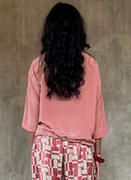 ound neck pink top in silk crepe on top of knees long pant batik decorated by Bali artisan