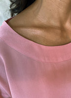 detail of a round neck pink top in silk crepe on top of knees long pant batik decorated by Bali artisan